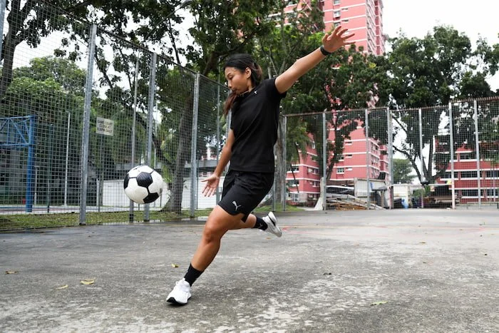 Nadhra Aqilah kicking soccer